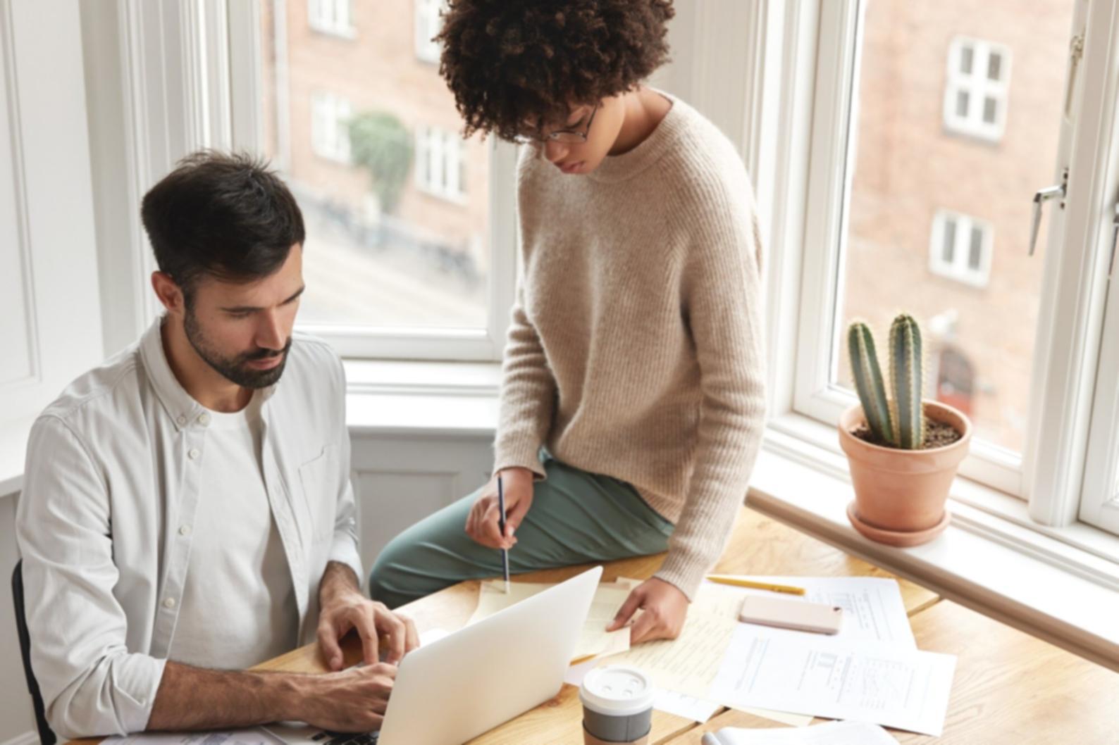 Mobile game interface design workshop showing students working on tablet screens with game prototypes